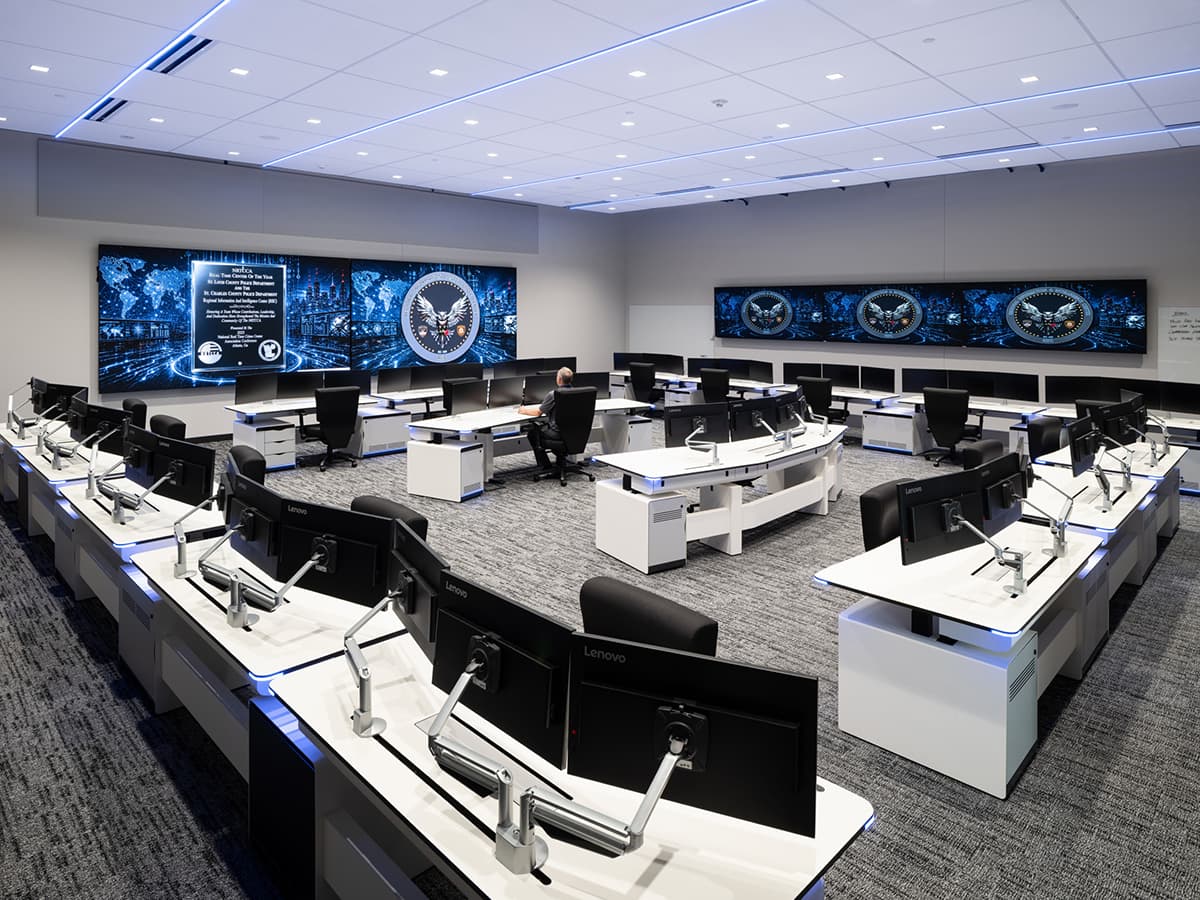 St. Louis County RTCC real-time crime center control room designed by Fountainhead Control Rooms, showing rows of operator consoles with dual monitors and an integrated video wall