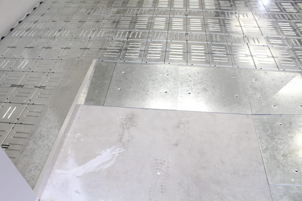 Raised access flooring panels staged on-site prior to install