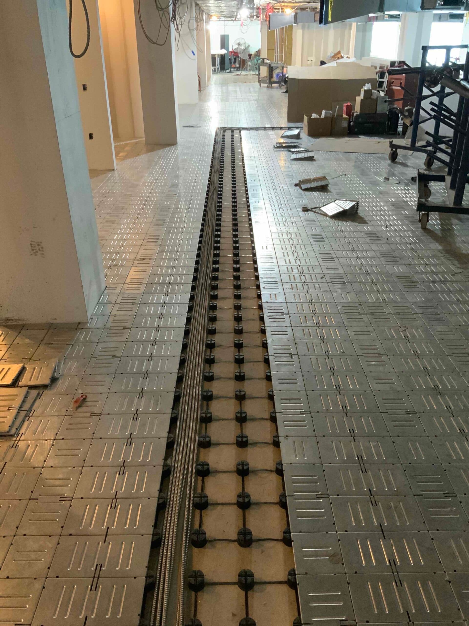 Low-profile raised access floor system installed in a control room